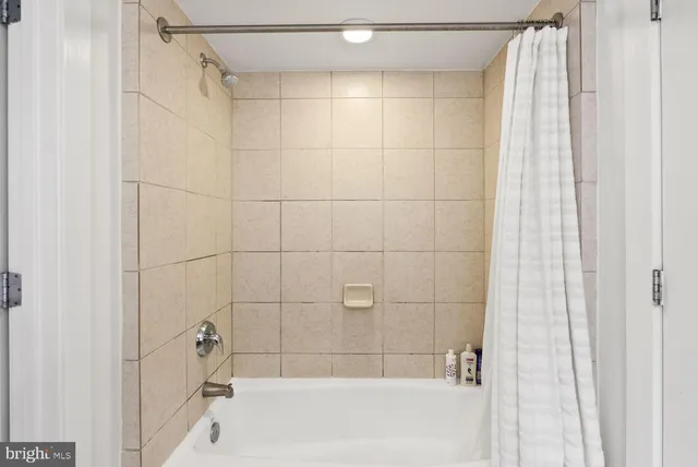 a bathroom with a shower and a bathtub