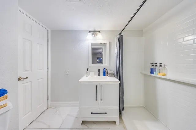 a bathroom with a sink a mirror a vanity and window