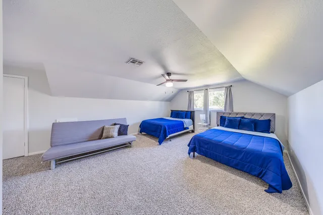 a living room with furniture and a ceiling fan