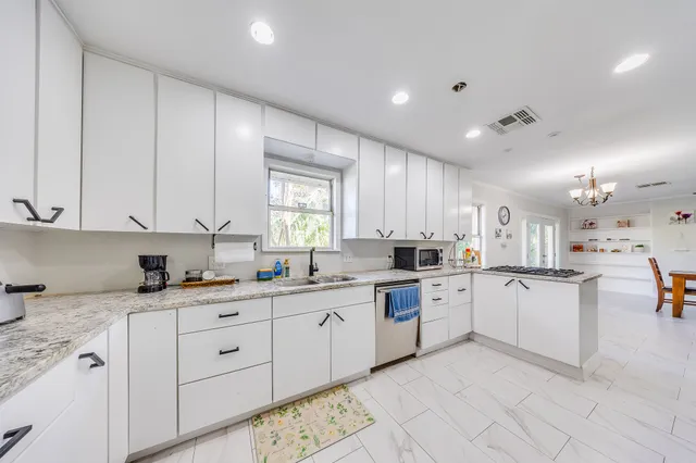 a kitchen with sink and cabinets