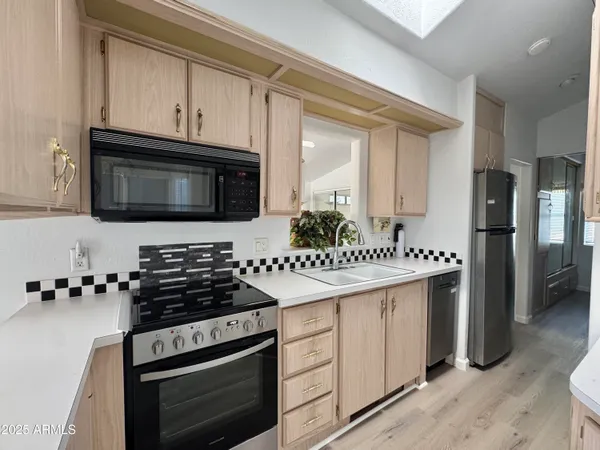 a kitchen with stainless steel appliances granite countertop a stove a refrigerator and a microwave