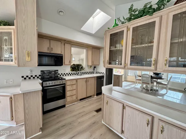 a kitchen with a sink stove and microwave