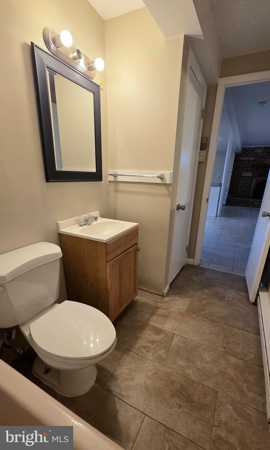 4400 4th Street Baltimore, MD 21225 - Photo 21 of 25 a white toilet sitting next to a bathroom sink