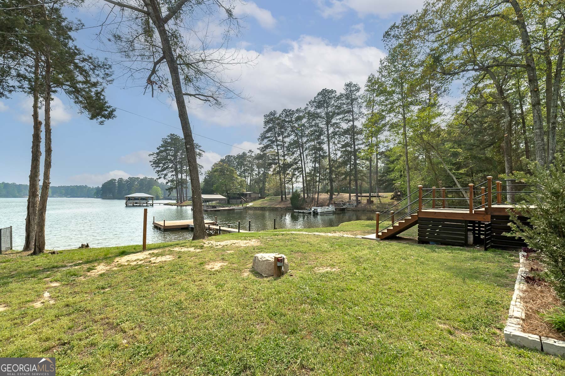 595 Barnetts Bridge Road Jackson, GA 30233 - Photo 41 of 47 a view of a swimming pool with a bench and trees around