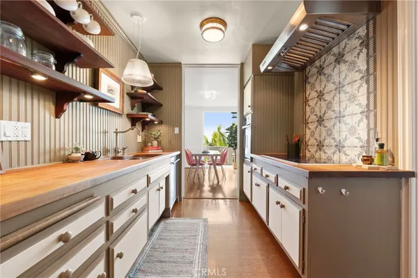 a view of a kitchen with racks on the wall