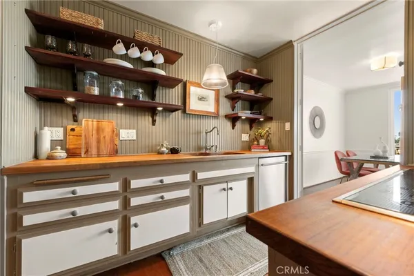 a kitchen with stainless steel appliances a sink and cabinets