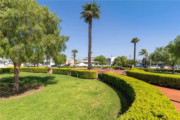 an aerial view of ocean and residential houses with outdoor space
