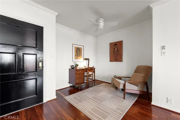 a workspace with wooden floor and furniture