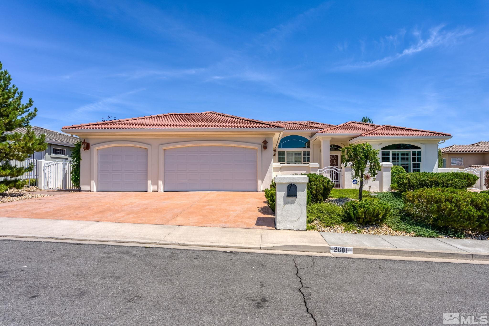 2681 Spearpoint Drive Reno, NV 89509 - Photo 1 of 36 a front view of a house with a yard
