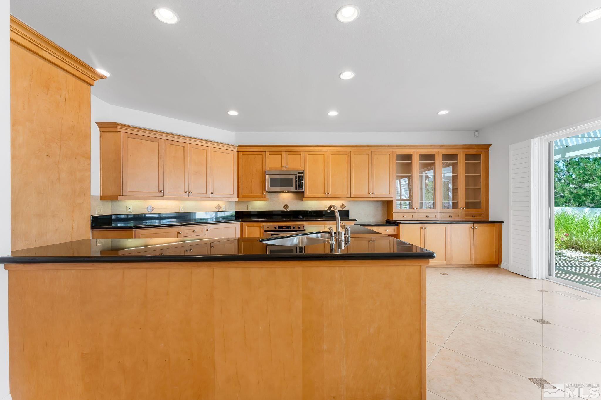 2681 Spearpoint Drive Reno, NV 89509 - Photo 13 of 36 a large white kitchen with a large window