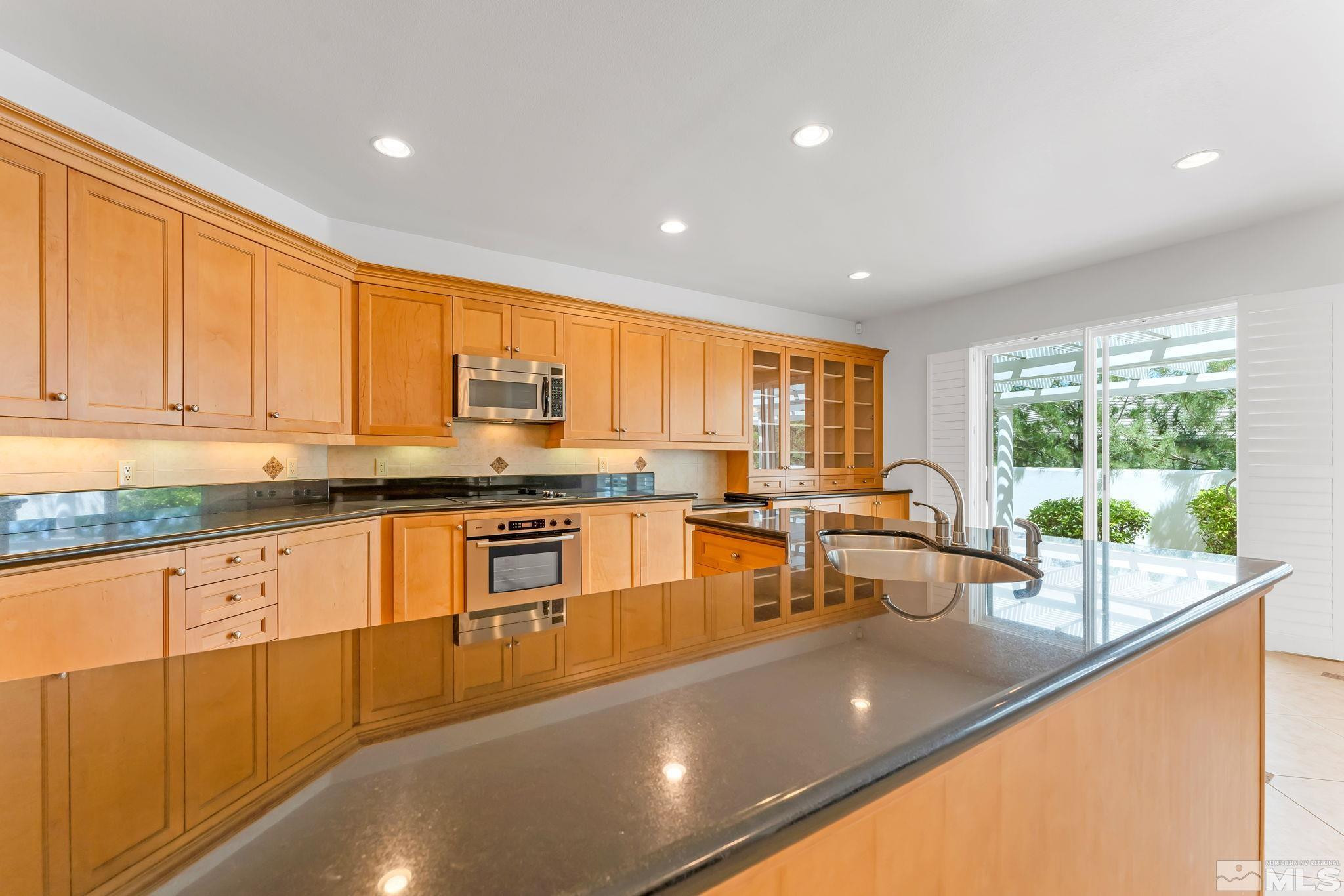 2681 Spearpoint Drive Reno, NV 89509 - Photo 14 of 36 a large kitchen with granite countertop a large window