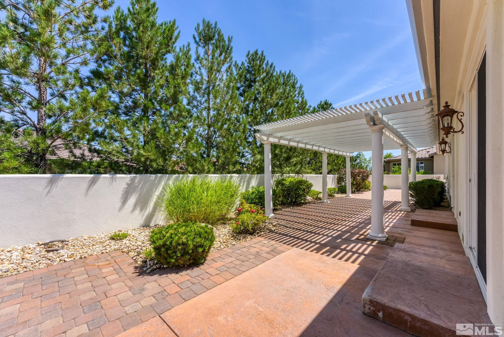 2681 Spearpoint Drive Reno, NV 89509 - Photo 31 of 36 a view of a patio with table and chairs potted plants with wooden floor and fence