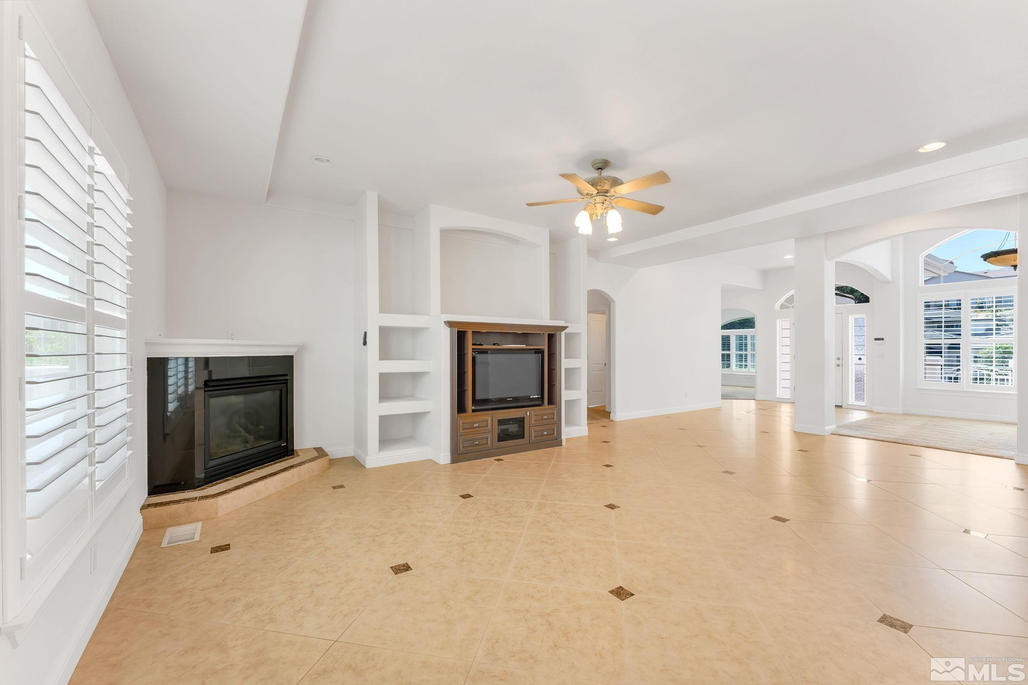 2681 Spearpoint Drive Reno, NV 89509 - Photo 10 of 36 an empty room with windows and fireplace