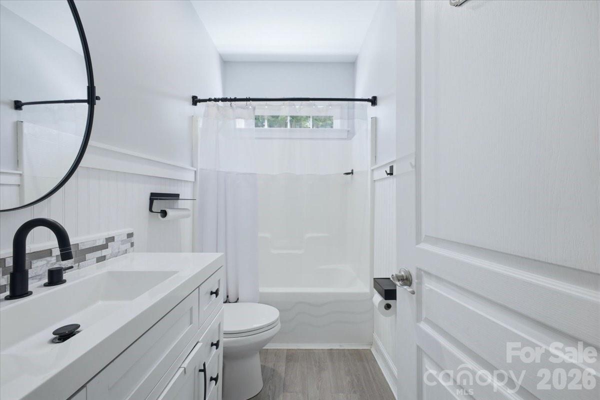 1825 Laveta Road Charlotte, NC 28269 - Photo 27 of 48 a bathroom with a sink a toilet and shower