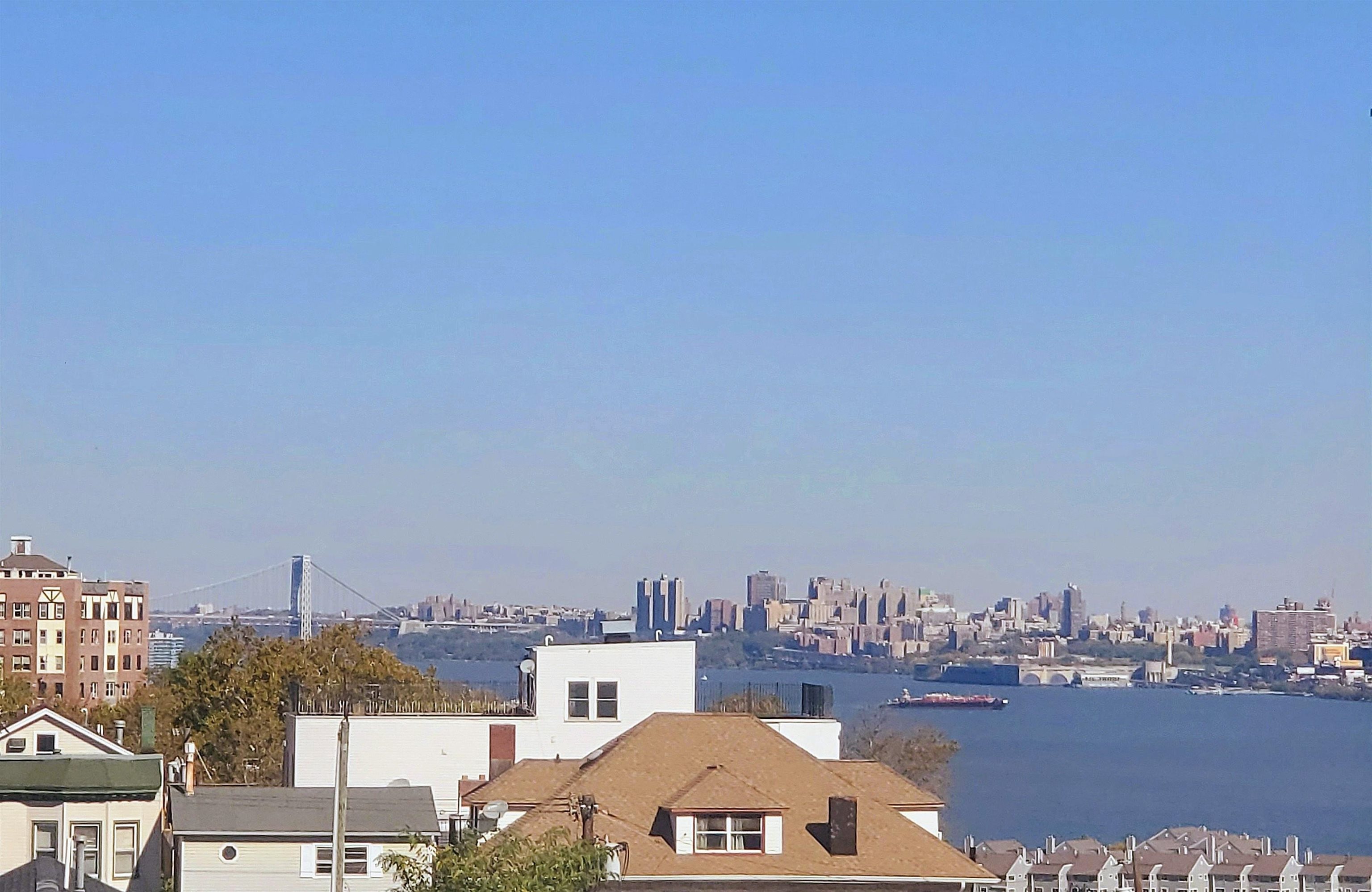 6701 Boulevard East, Unit E4 West New York, NJ 07093 - Photo 2 of 12 a view of a city and a mountain