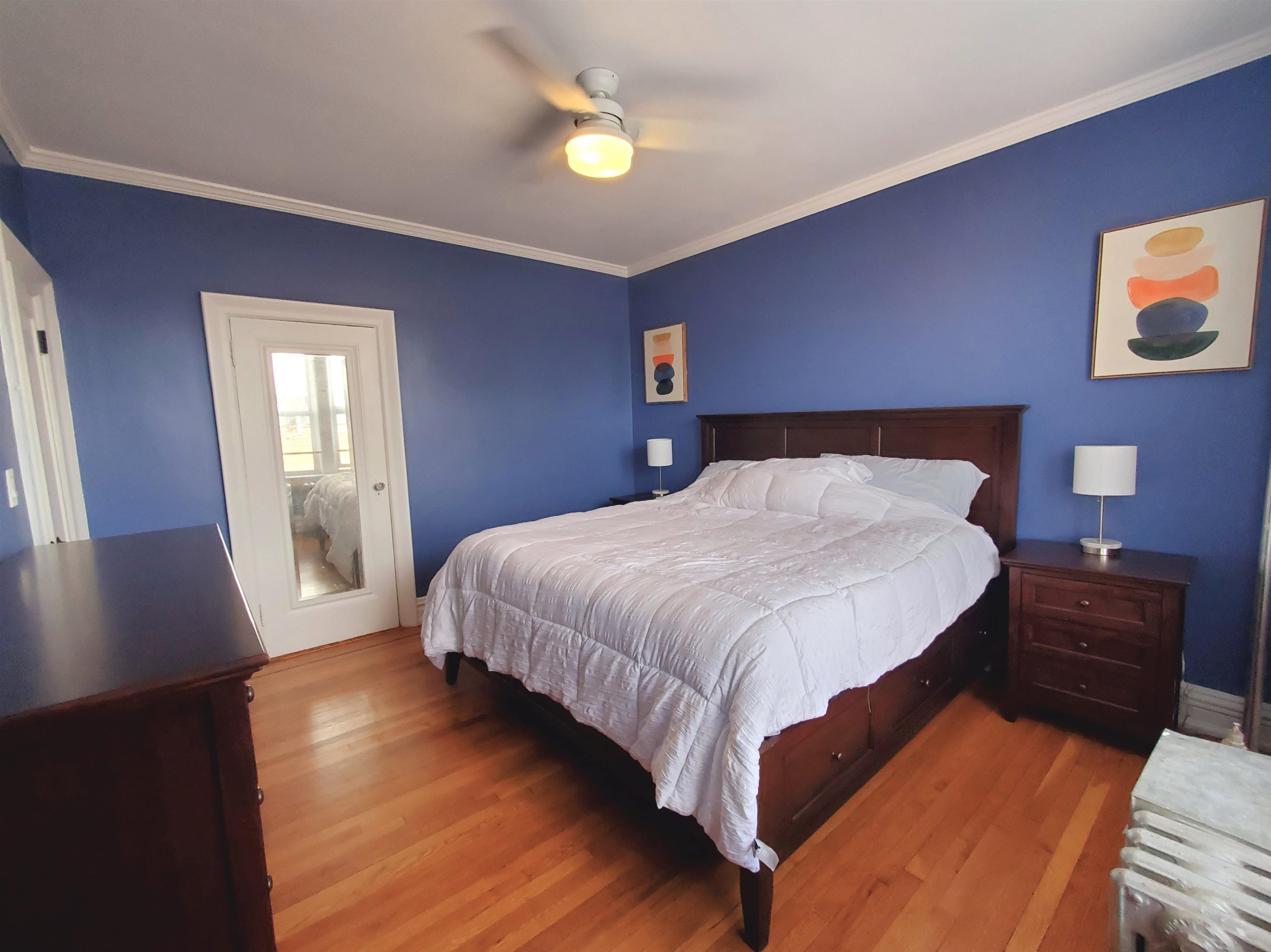 6701 Boulevard East, Unit E4 West New York, NJ 07093 - Photo 5 of 12 a bedroom with a bed and a lamp on dresser