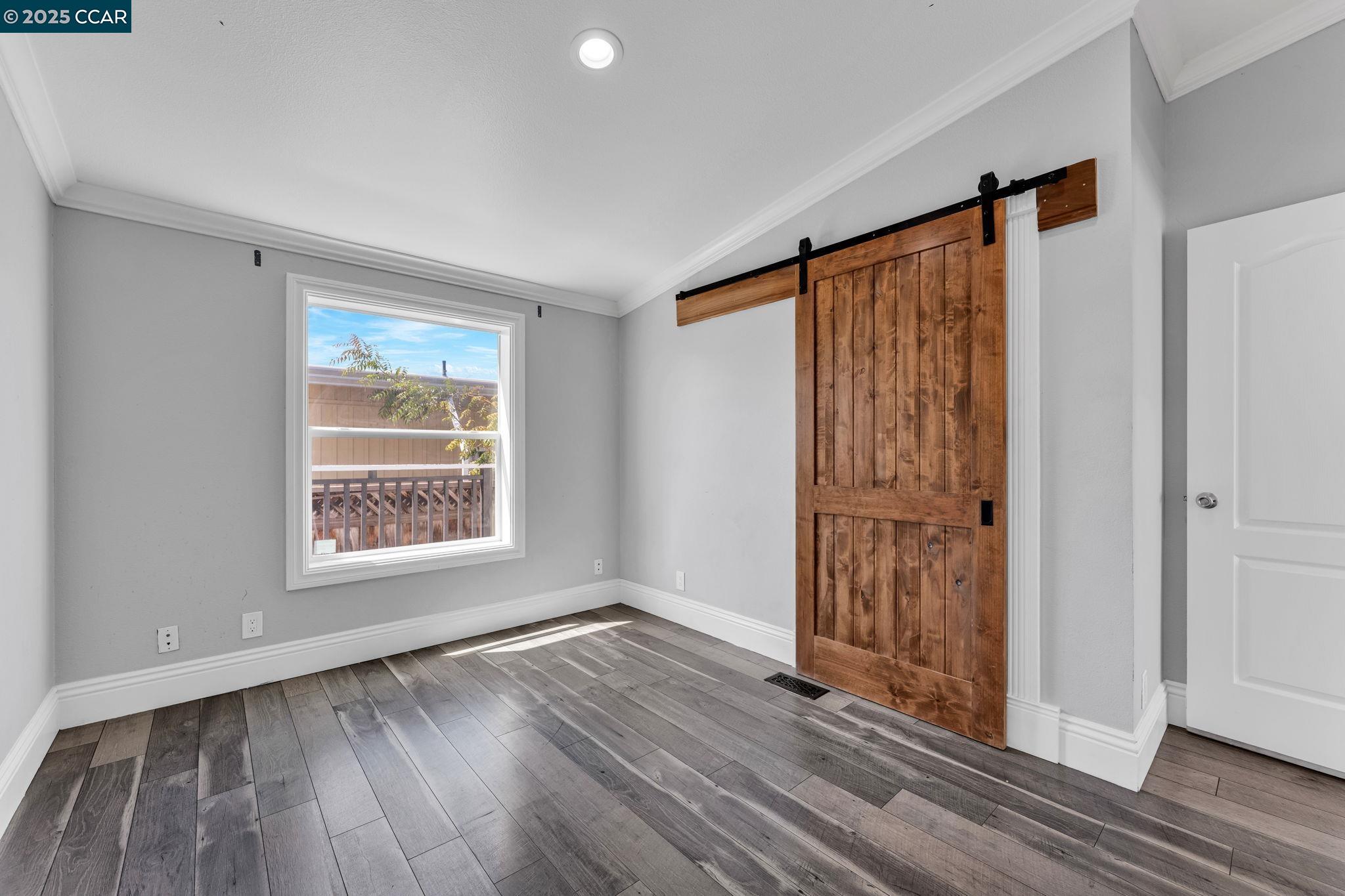 189 Suez Drive, Unit 72 Pacheco, CA 94553 - Photo 16 of 45 an empty room with wooden floor and a window