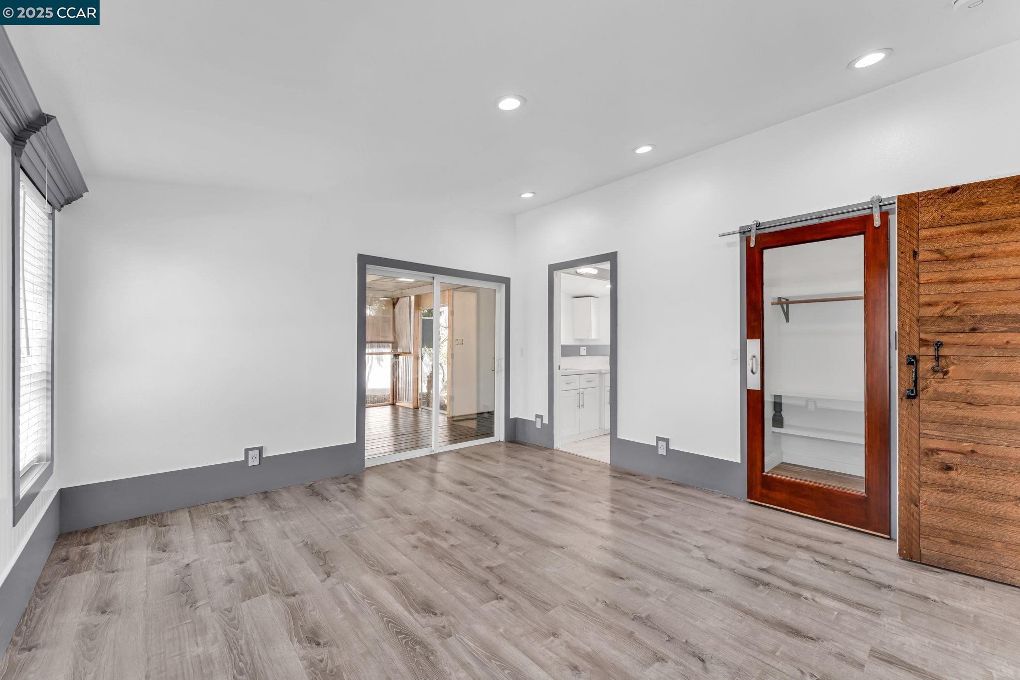 189 Suez Drive, Unit 72 Pacheco, CA 94553 - Photo 17 of 45 an empty room with wooden floor and windows