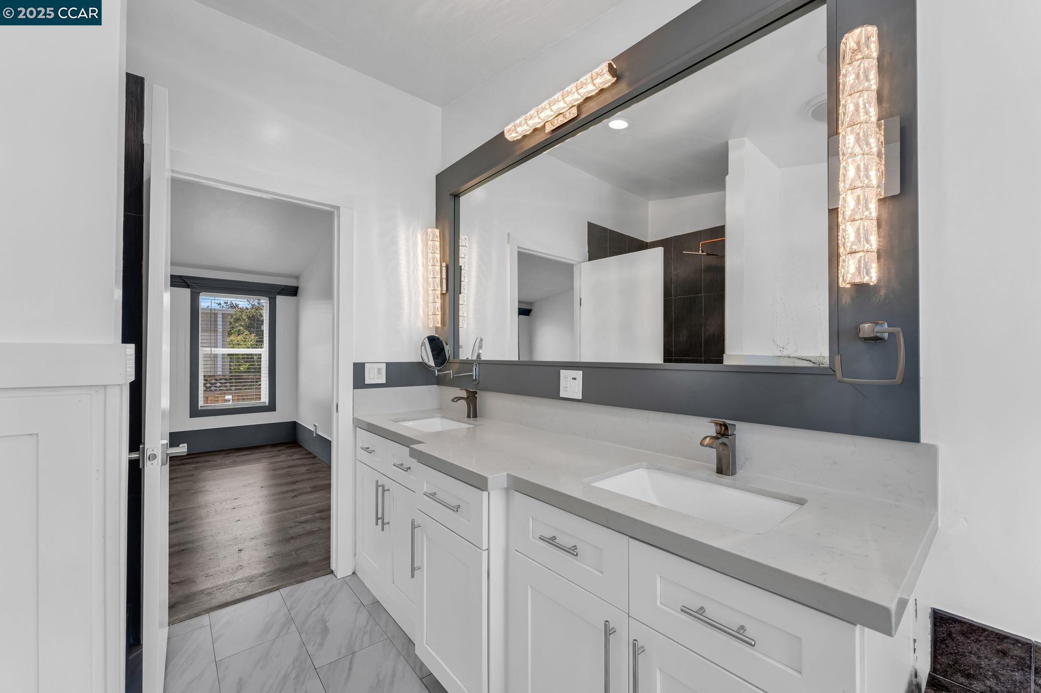 189 Suez Drive, Unit 72 Pacheco, CA 94553 - Photo 20 of 45 a bathroom with a double vanity sink and mirror