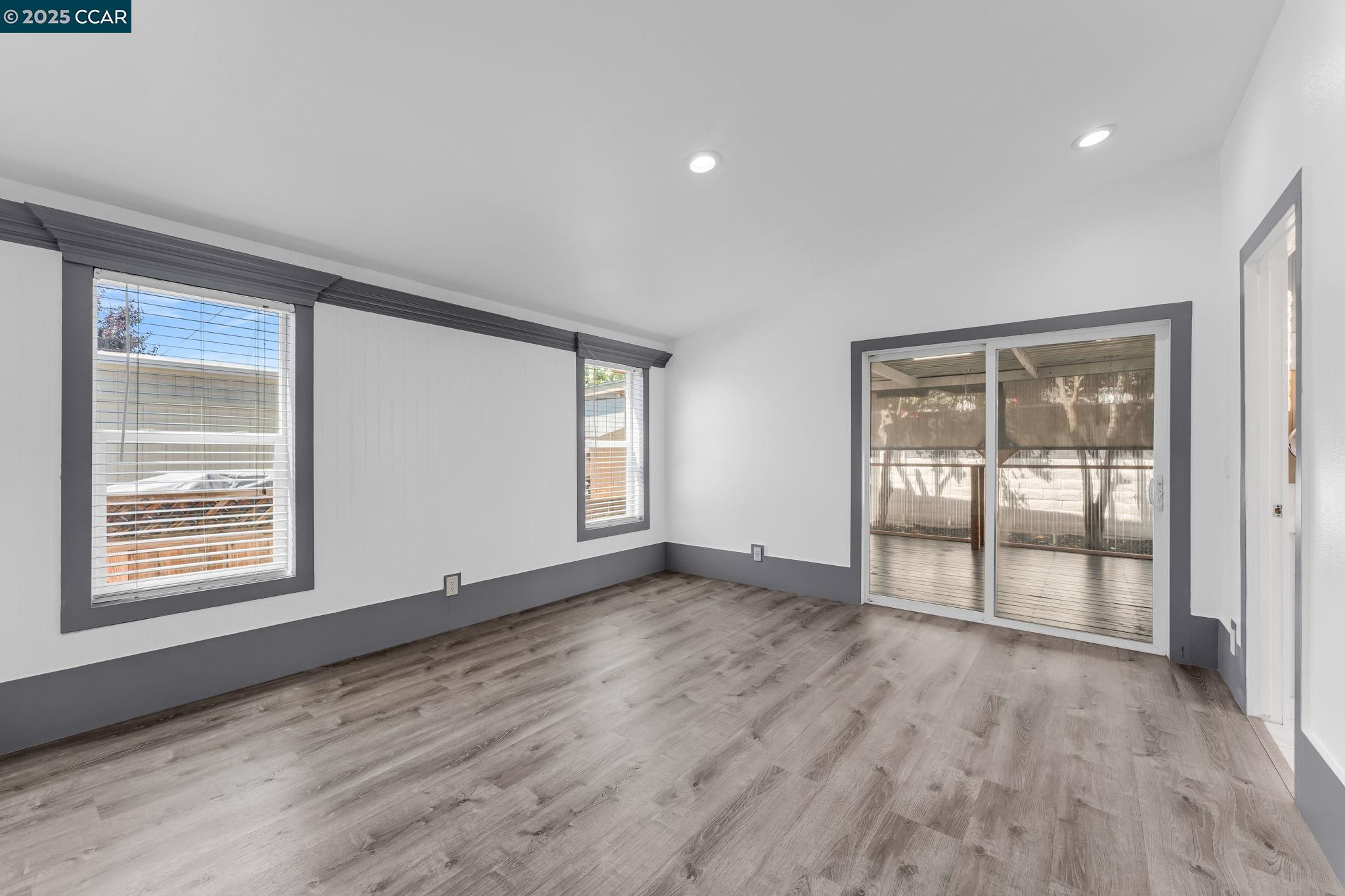 189 Suez Drive, Unit 72 Pacheco, CA 94553 - Photo 24 of 45 an empty room with wooden floor and windows