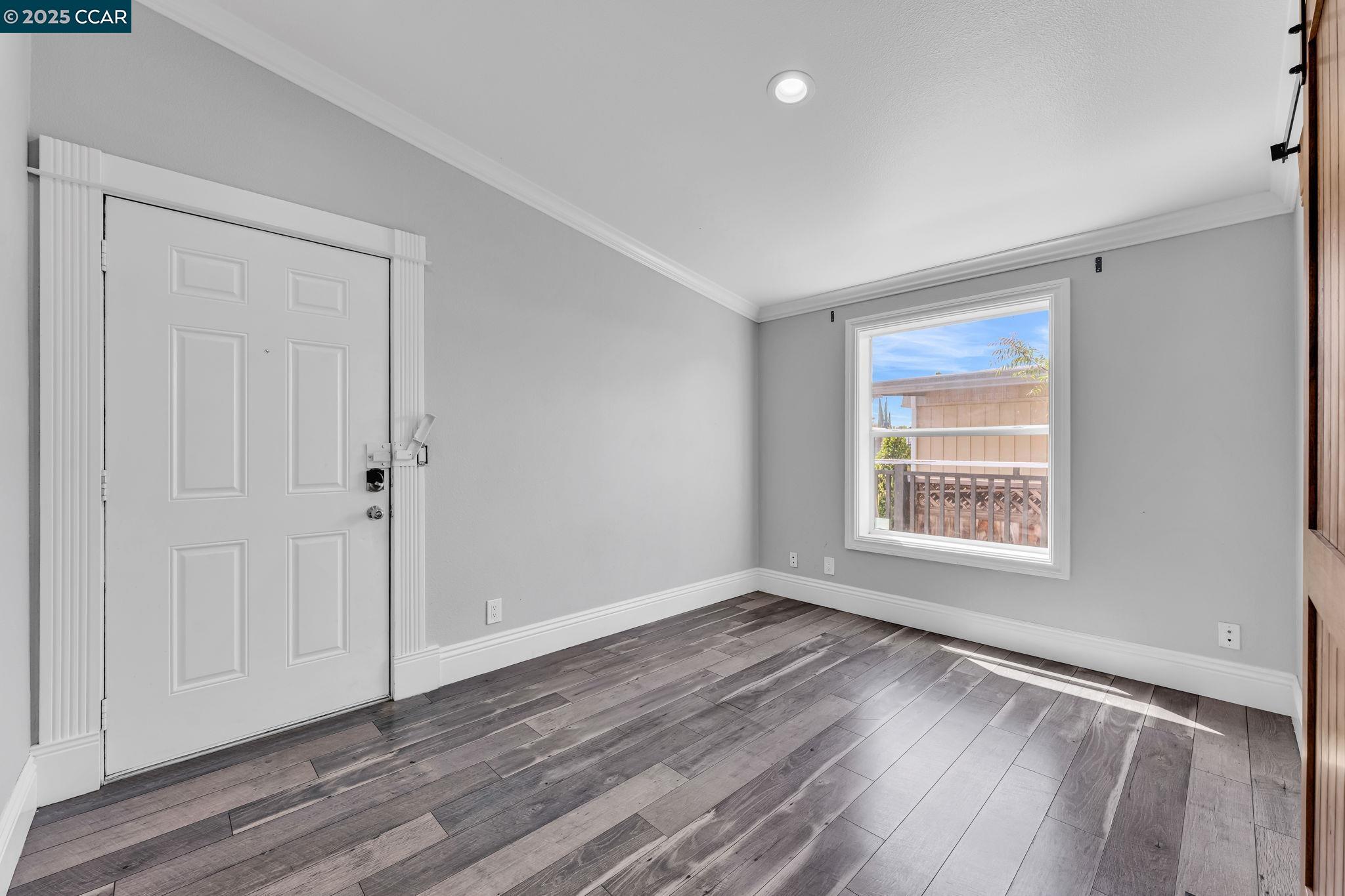 189 Suez Drive, Unit 72 Pacheco, CA 94553 - Photo 32 of 45 a view of an empty room with wooden floor and a window