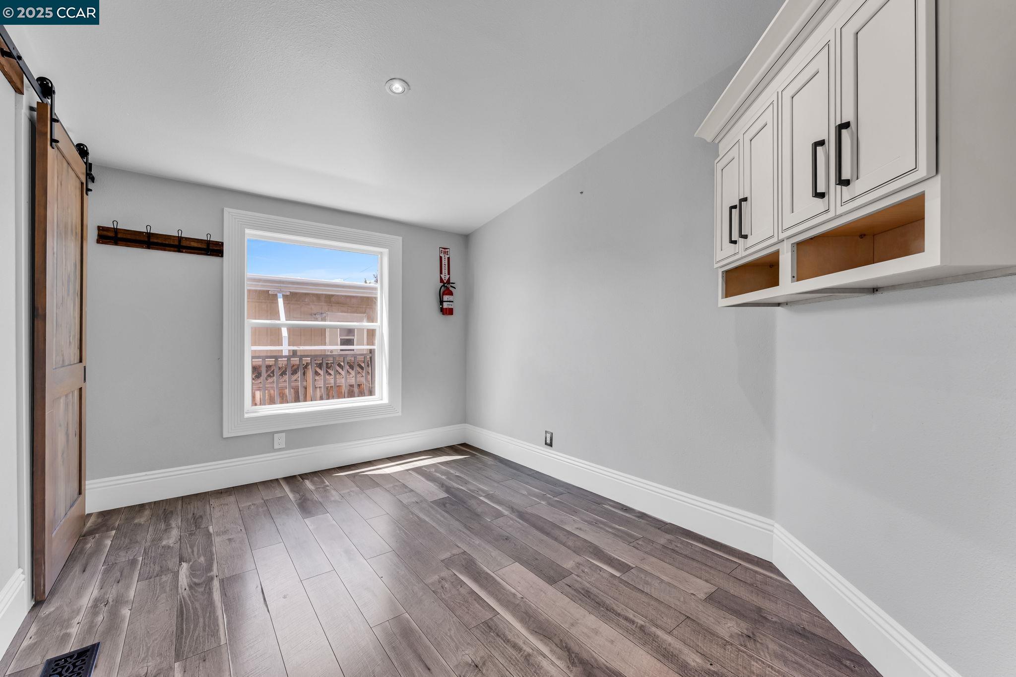 189 Suez Drive, Unit 72 Pacheco, CA 94553 - Photo 37 of 45 a view of an empty room with wooden floor and a window