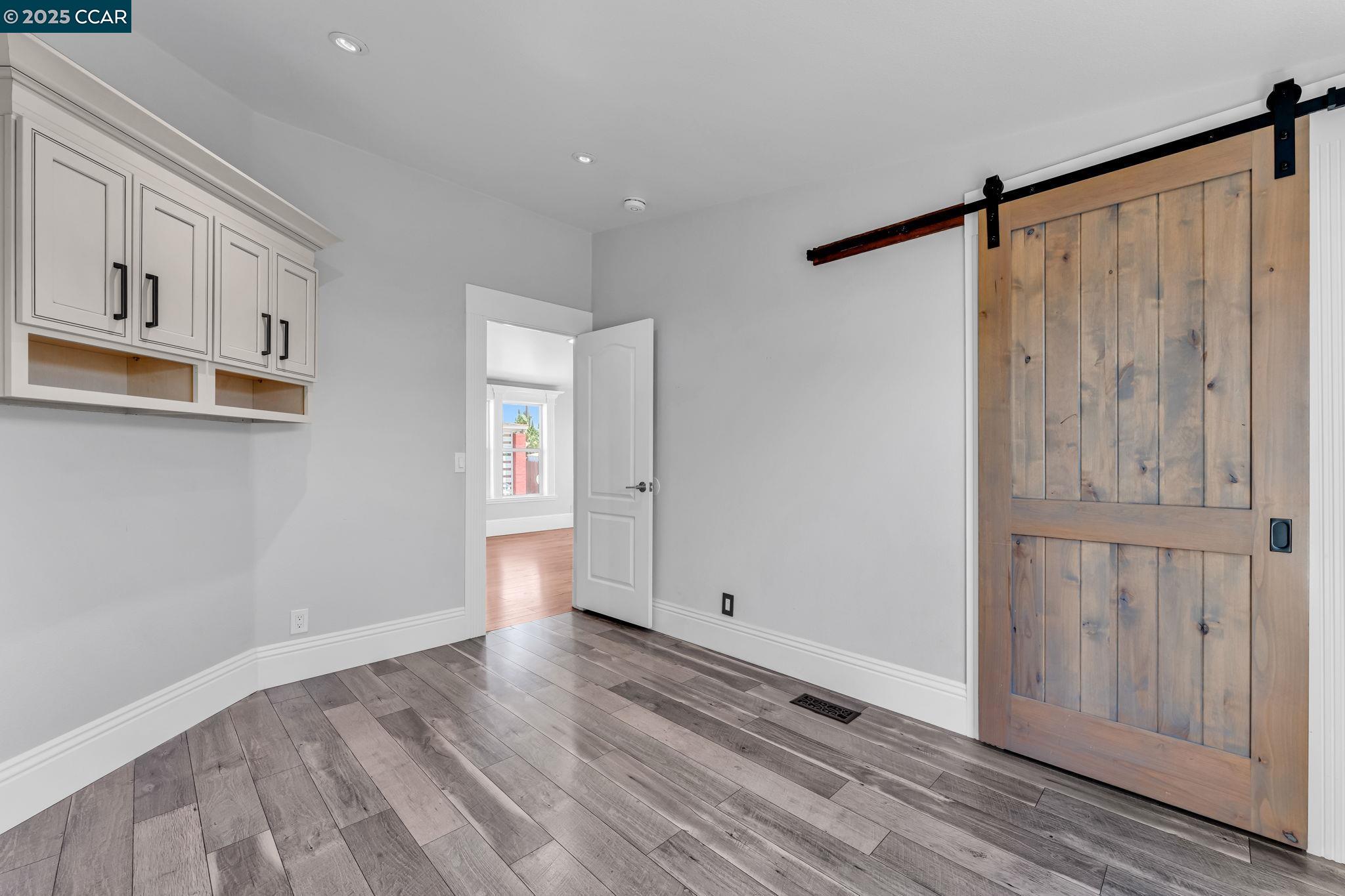 189 Suez Drive, Unit 72 Pacheco, CA 94553 - Photo 39 of 45 a view of an empty room with wooden floor and a window