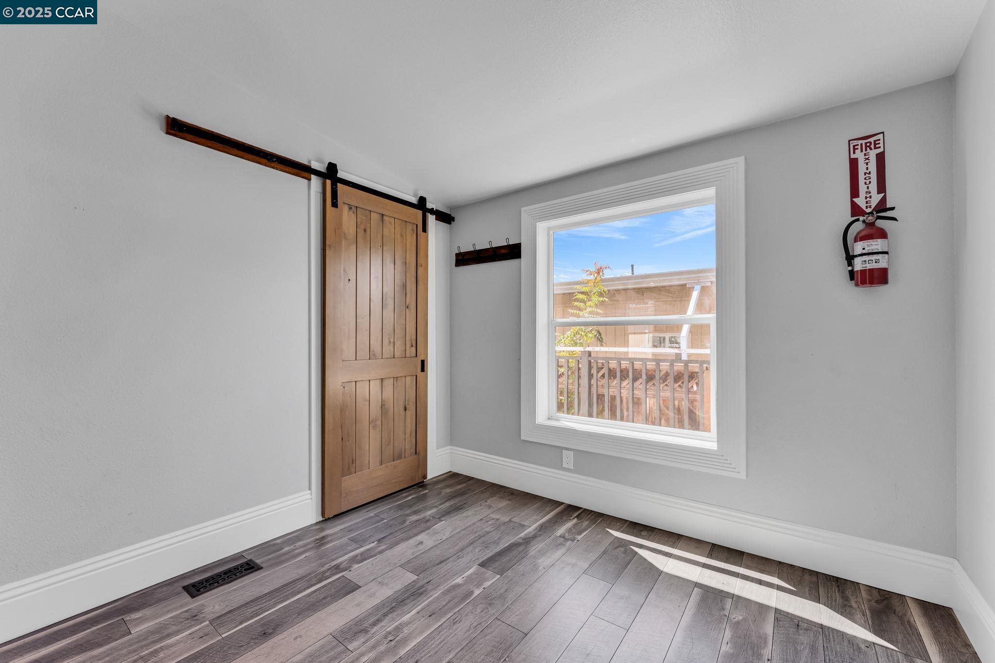 189 Suez Drive, Unit 72 Pacheco, CA 94553 - Photo 40 of 45 an empty room with wooden floor closet and windows