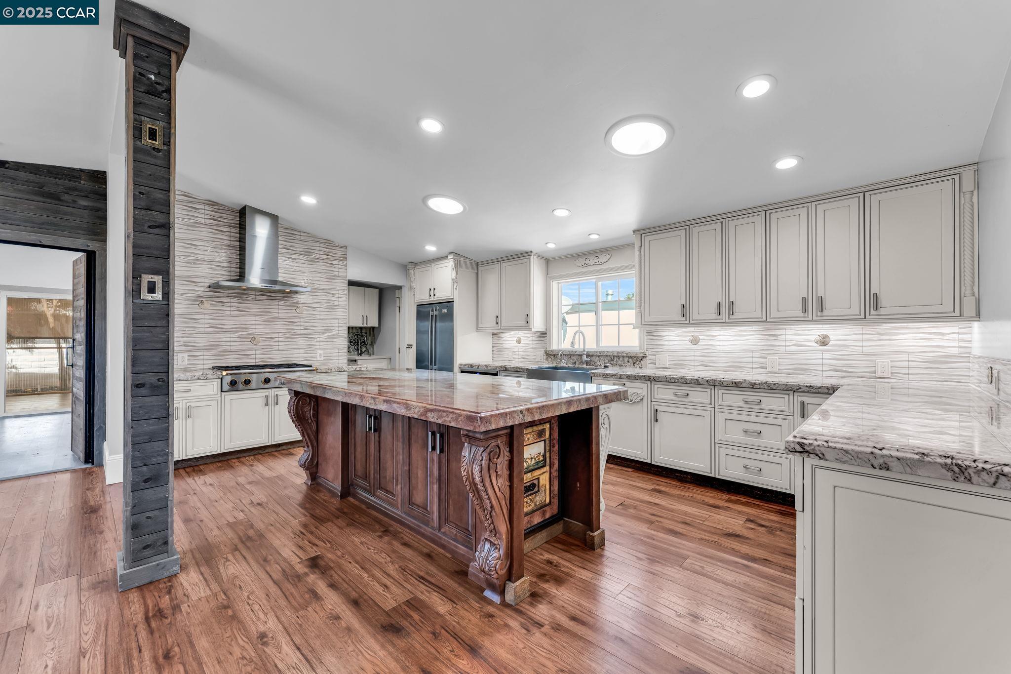 189 Suez Drive, Unit 72 Pacheco, CA 94553 - Photo 4 of 45 a kitchen with stainless steel appliances granite countertop wooden floors and wooden cabinets