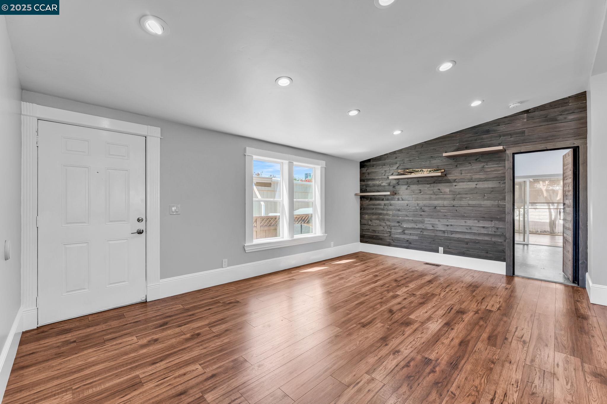 189 Suez Drive, Unit 72 Pacheco, CA 94553 - Photo 7 of 45 a view of an empty room with wooden floor and a window