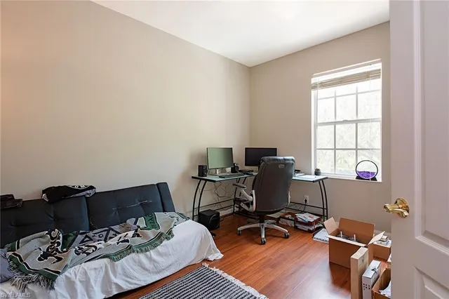 a view of a workspace with furniture and a window