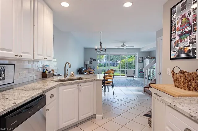a kitchen with stainless steel appliances granite countertop a sink and cabinets