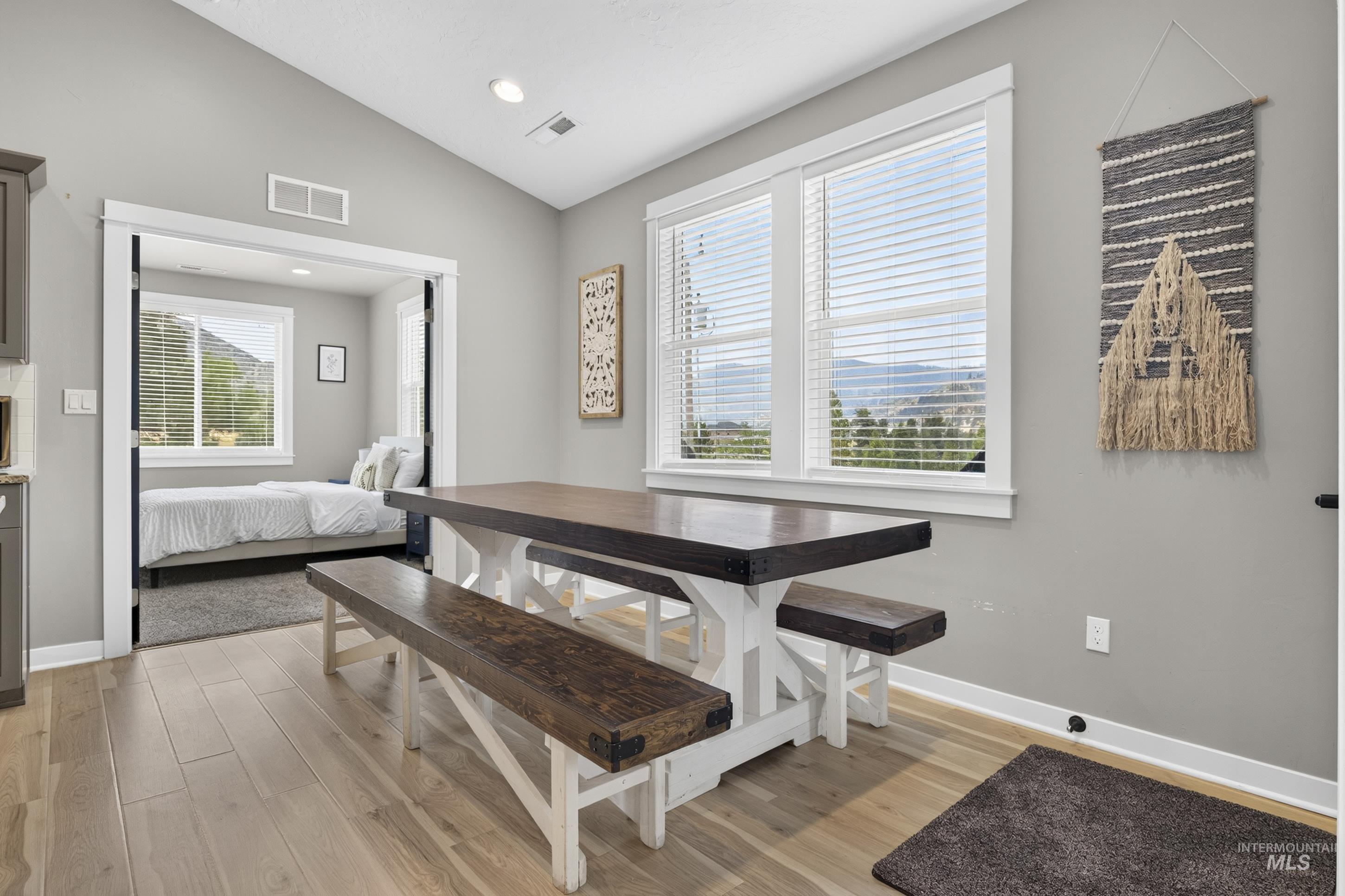 132 Mores Creek Rim Road Boise, ID 83716 - Photo 15 of 44 Recessed lighting, wood-finish flooring, vaulted ceiling, white trim windows, and mountain scenery