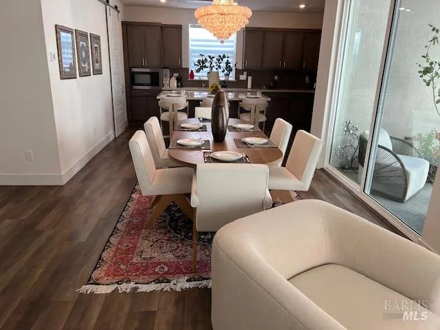 a dining room with furniture a rug and wooden floor