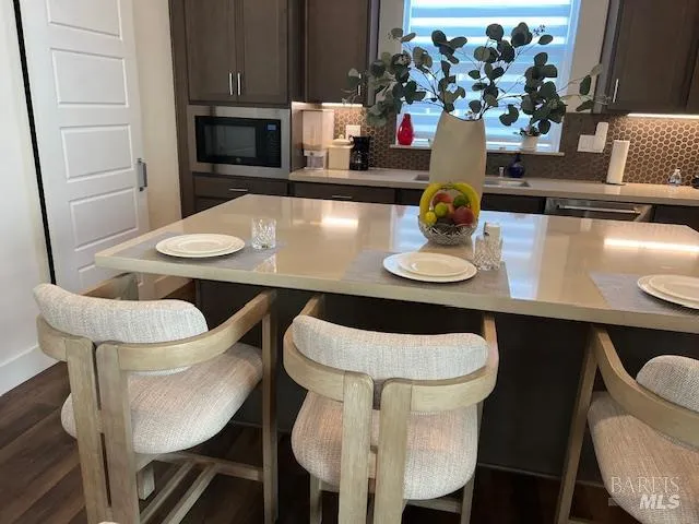 a kitchen with granite countertop a sink a stove and cabinets
