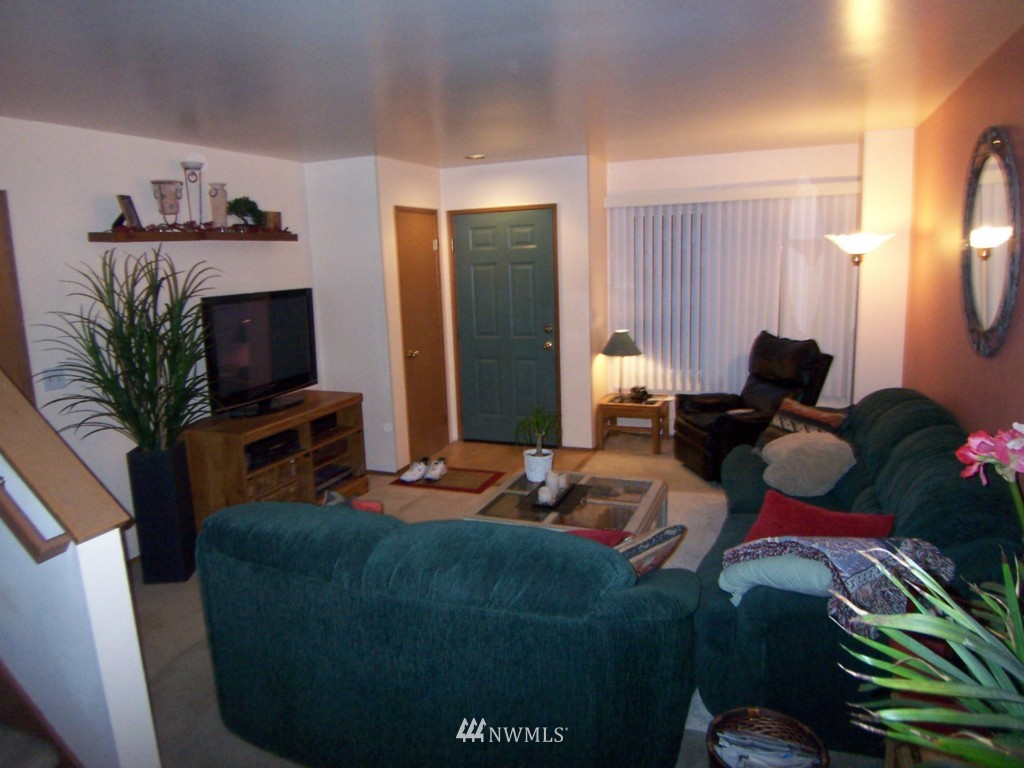 10624 Northeast 175th Street Bothell, WA 98011 - Photo 3 of 17 a living room with furniture a flat screen tv and a fireplace
