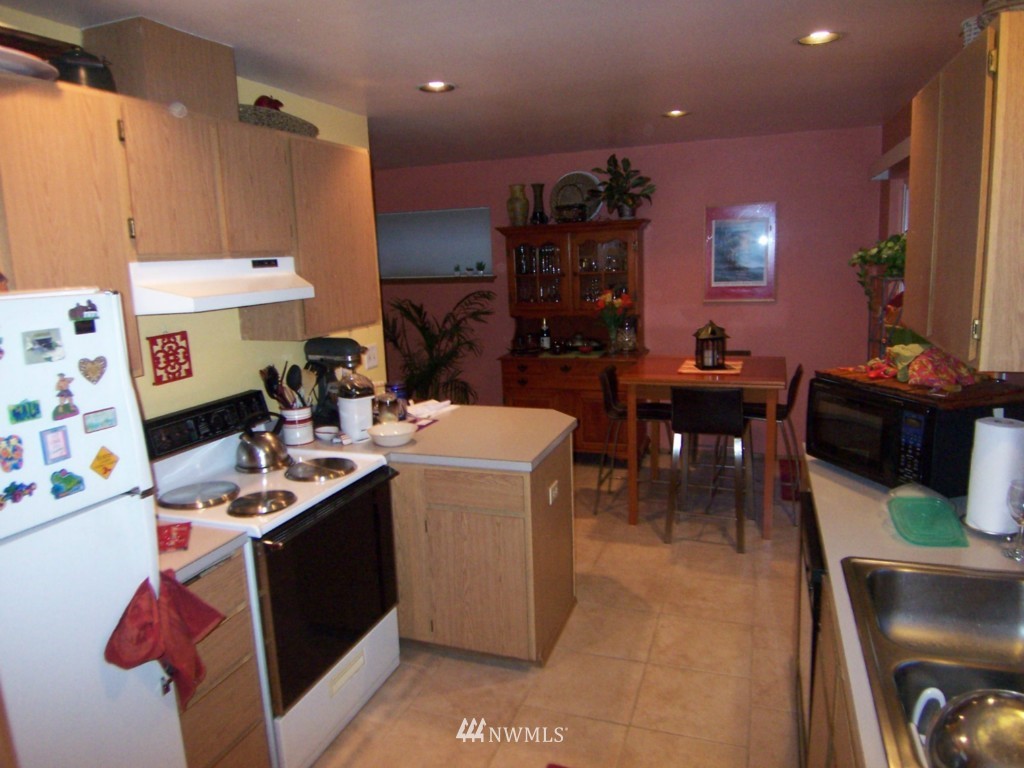 10624 Northeast 175th Street Bothell, WA 98011 - Photo 6 of 17 a work place with kitchen island granite countertop furniture and a dining table