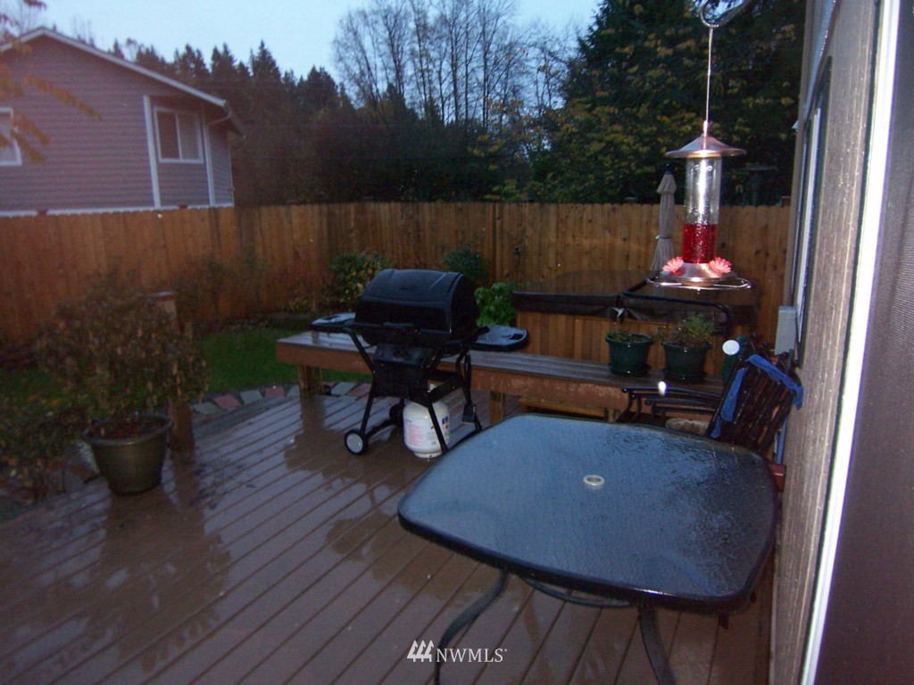 10624 Northeast 175th Street Bothell, WA 98011 - Photo 9 of 17 a view of balcony with wooden floor and outdoor seating