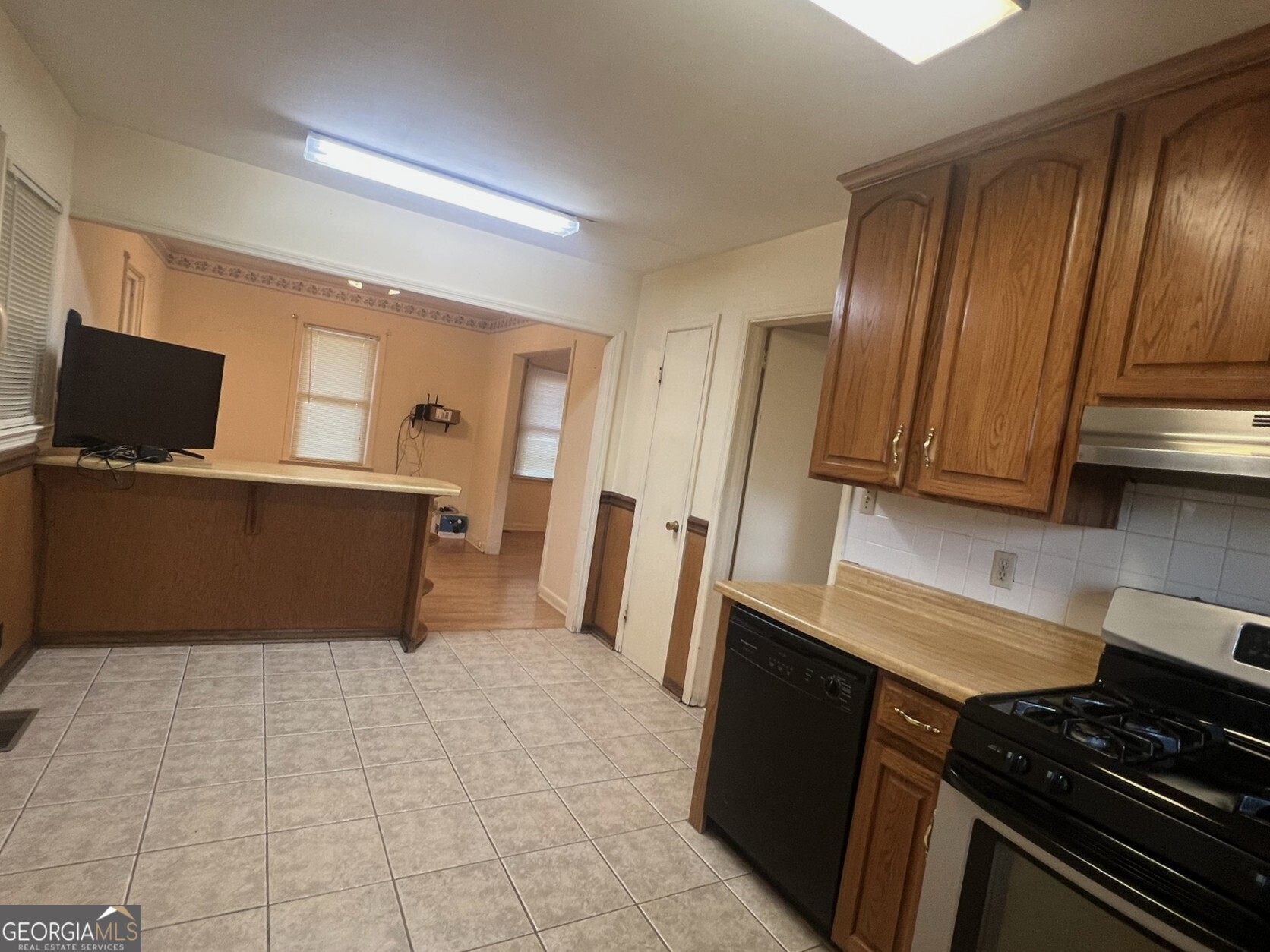 3640 South Walden Road Macon, GA 31216 - Photo 7 of 21 a kitchen with wooden cabinets and a stove top oven