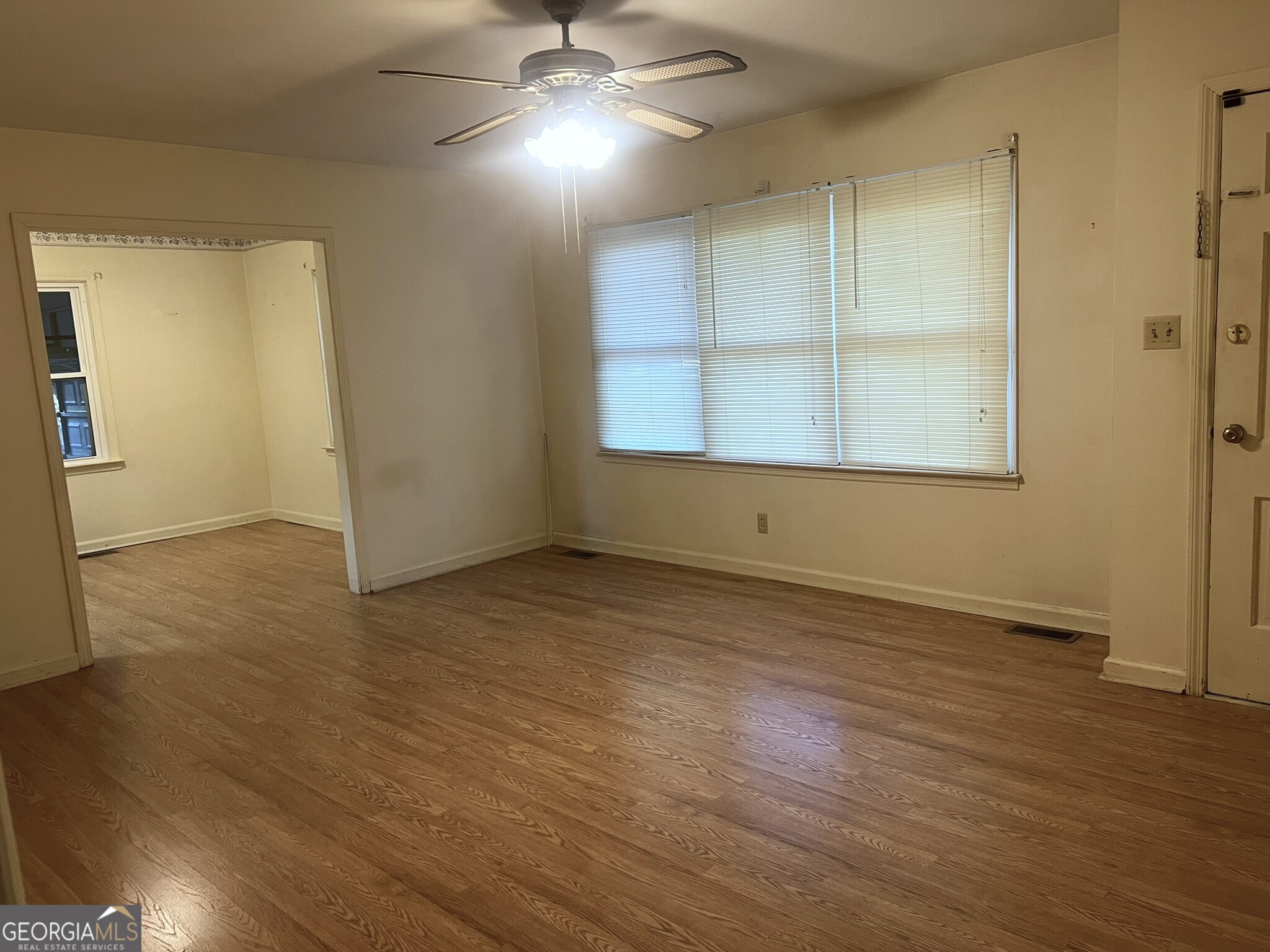 3640 South Walden Road Macon, GA 31216 - Photo 8 of 21 an empty room with wooden floor cabinet and windows