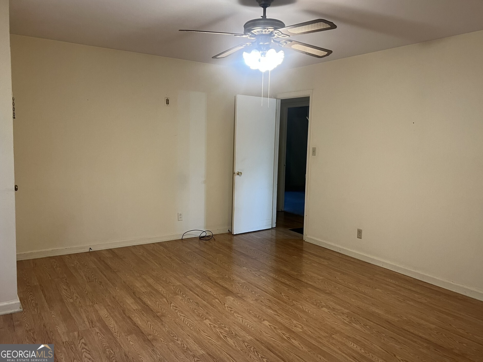 3640 South Walden Road Macon, GA 31216 - Photo 9 of 21 an empty room with wooden floor chandelier fan and closet area