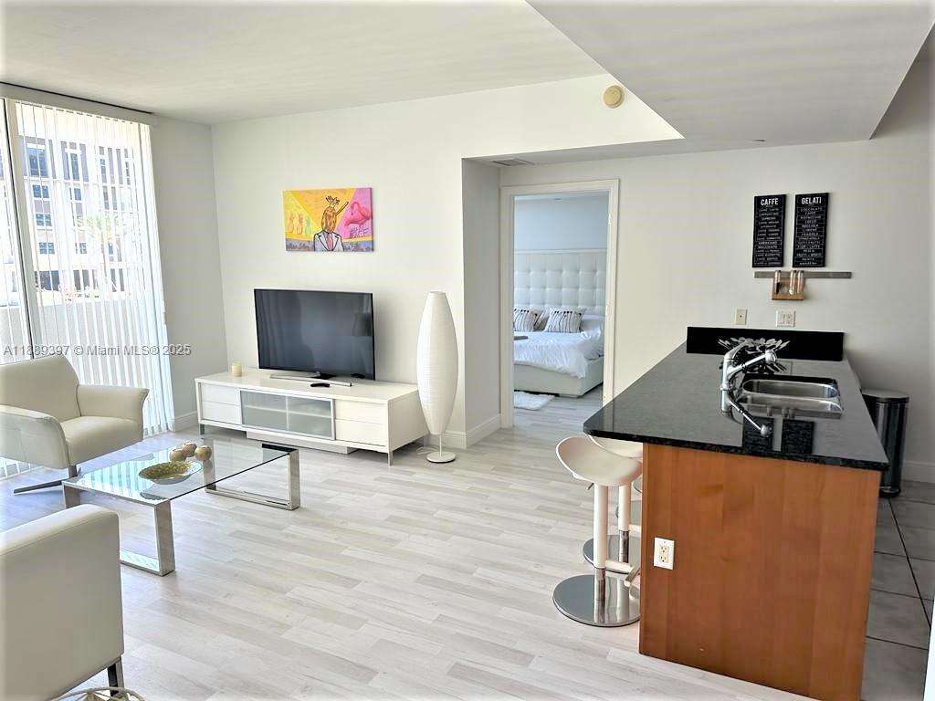 4100 Salzedo Street, Unit 702 Coral Gables, FL 33146 - Photo 11 of 15 a living room with furniture and a flat screen tv