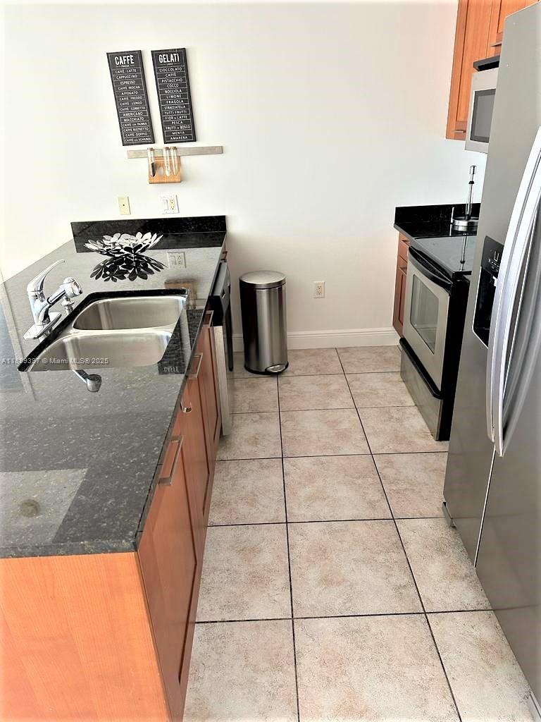 4100 Salzedo Street, Unit 702 Coral Gables, FL 33146 - Photo 10 of 15 a kitchen with a stove top oven and sink