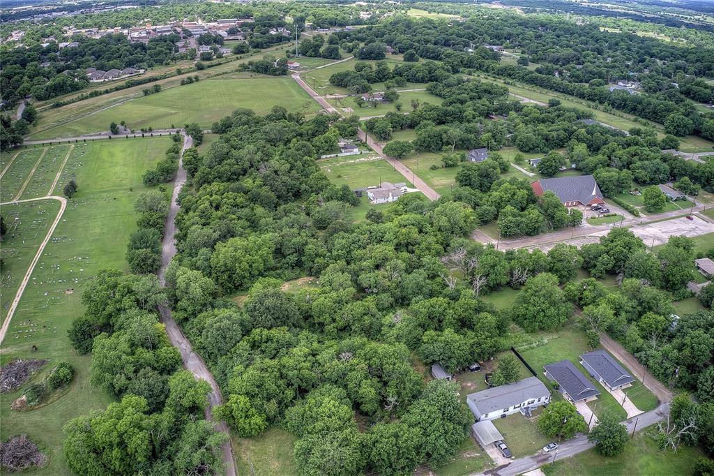 0 Sycamore Street Commerce, TX 75428 - Photo 6 of 14 an aerial view of residential houses with outdoor space and trees