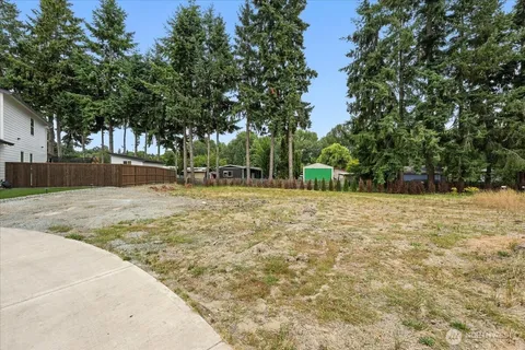 a backyard of a house with large trees