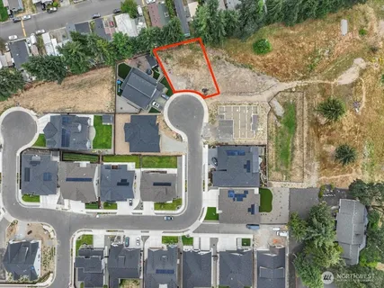 an aerial view of residential houses with outdoor space and lake view