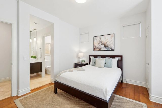 a bedroom with a bed and a painting on the wall