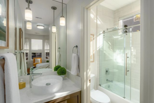 a bathroom with a sink a toilet and shower