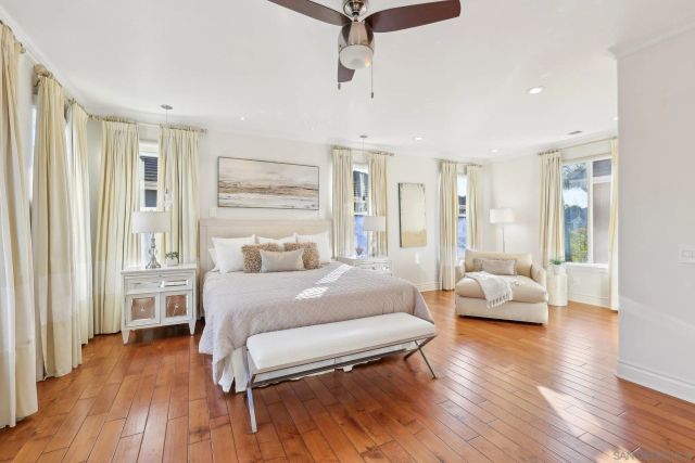 a spacious bedroom with a bed and furniture