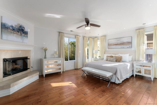 a spacious bedroom with a bed couch and window